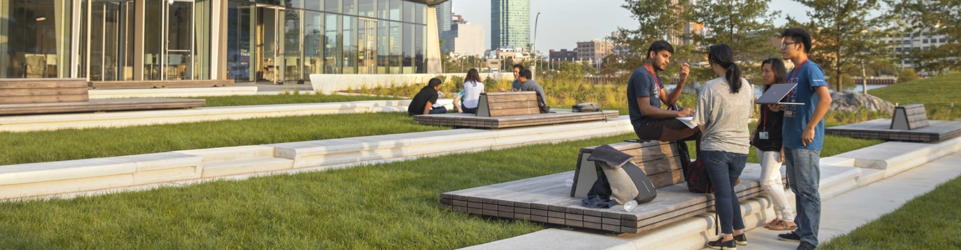 students in front of a modern glass building