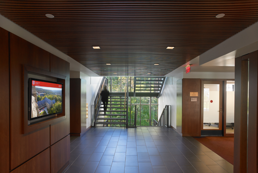 Interior showing an open staircase and wall screens of an academic building