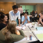 students gathered around a table