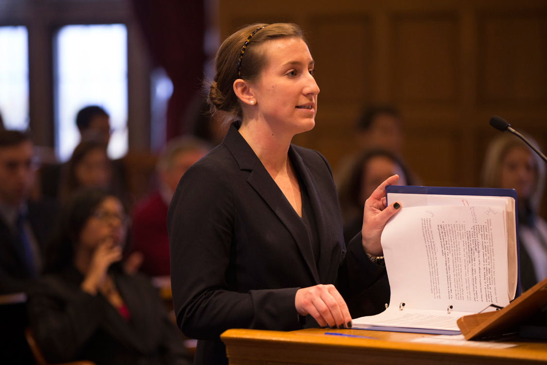 young woman presenting evidence at a podium