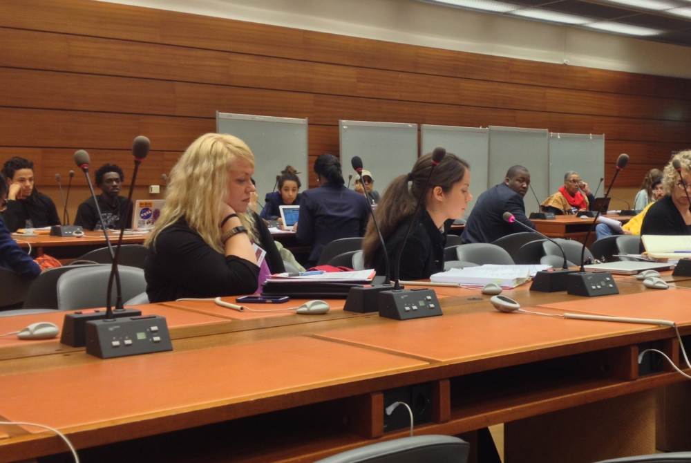 conference room with multiple rows of tables and people