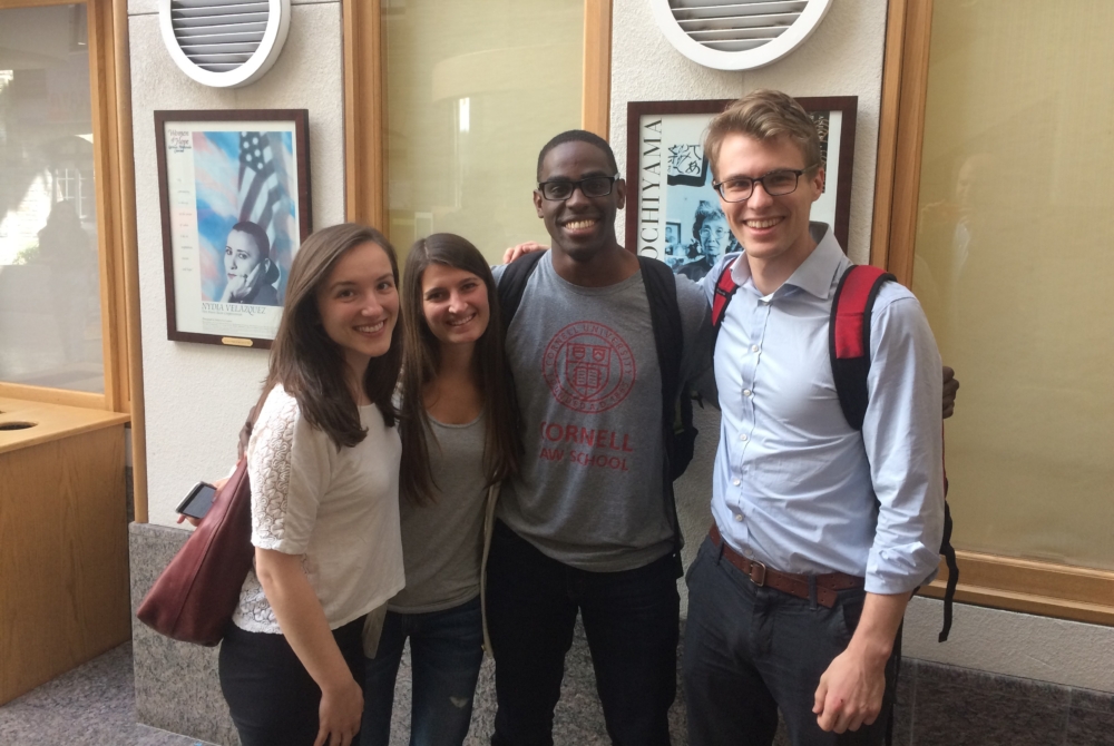 four students in an academic building