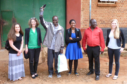 A group of students, faculty and Malawian people outside a prison.