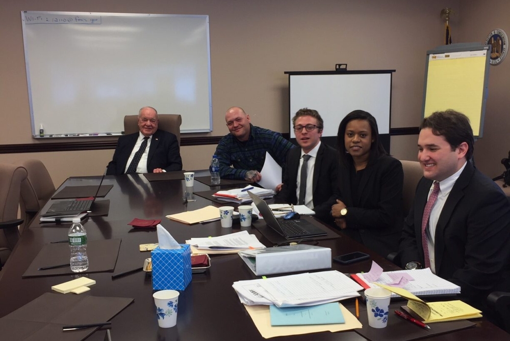 Law students Michael Iadvaia, Teri Tillman, Daniel Baumel with Arbitrator Anner and a witness in a termination case.