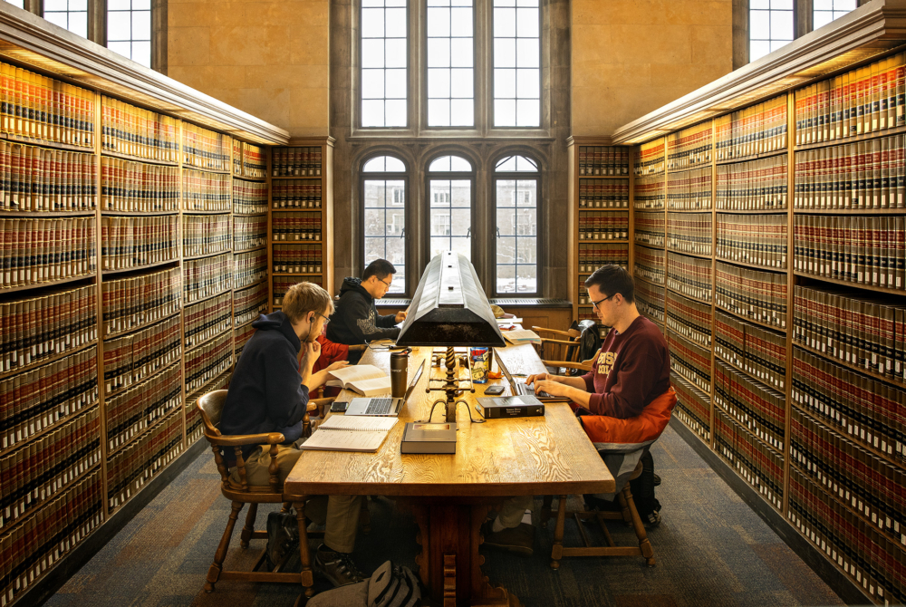 a group of students sitting in a table in a library