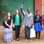 A group of students, faculty and Malawian people outside a prison.