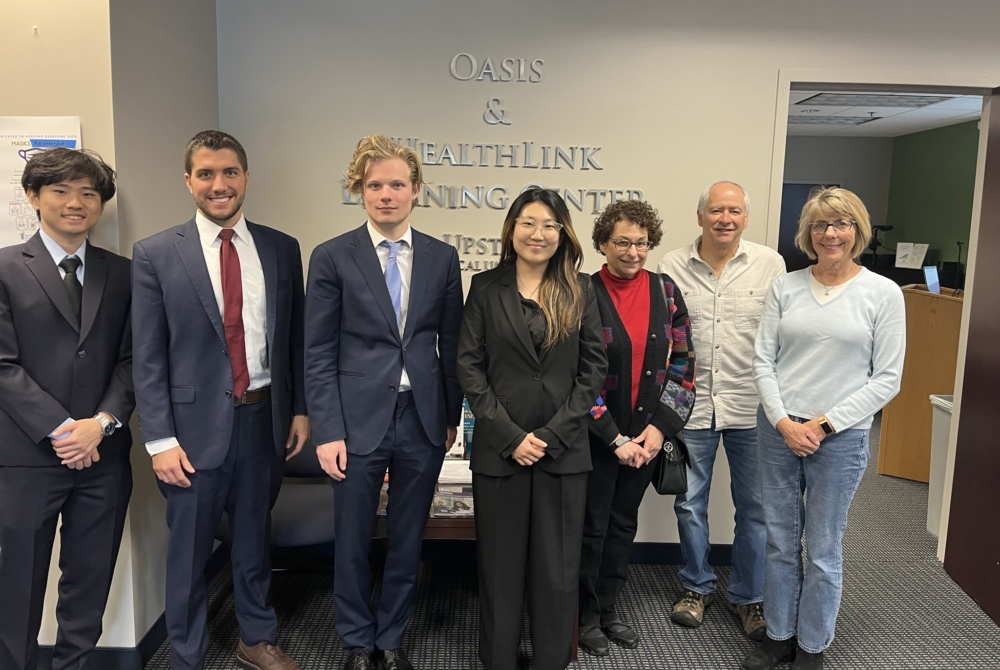 group of people in front of a sign saying Oasis and Earthlink Learning Center