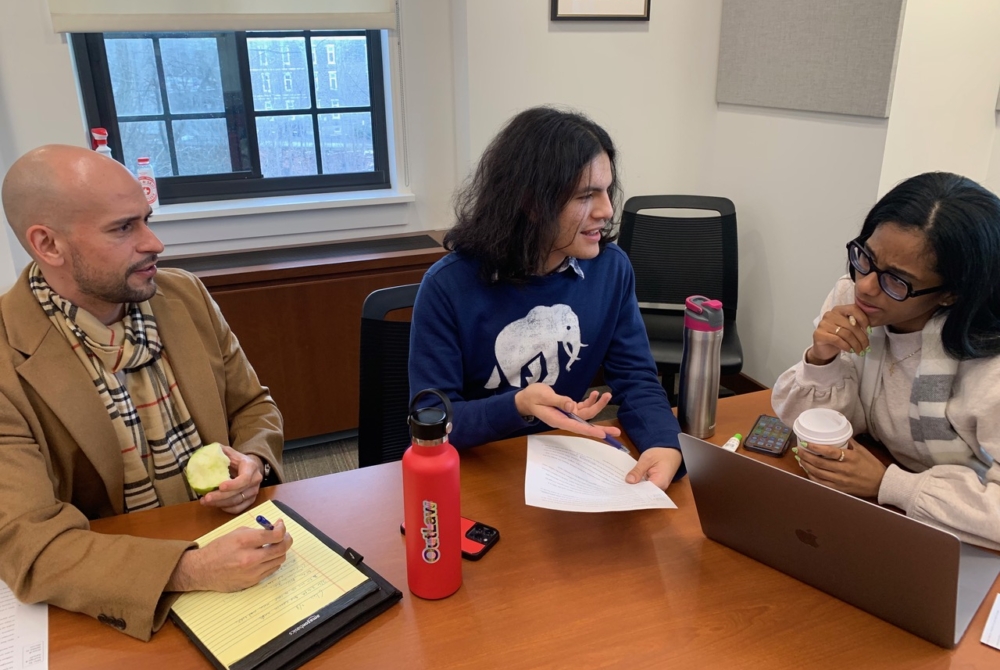 three students in discussion