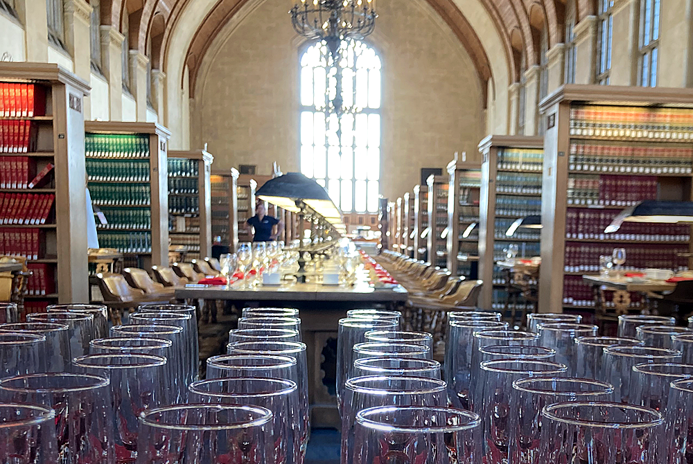 Photo of champagne flutes in the foreground and the gould reading room in the background