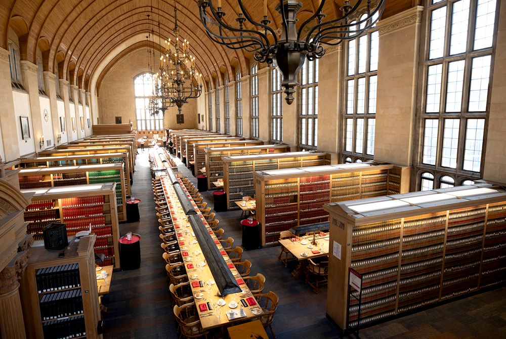 Arial photo of the Gould REading room with the tables set with red cloth napkins for the student feast
