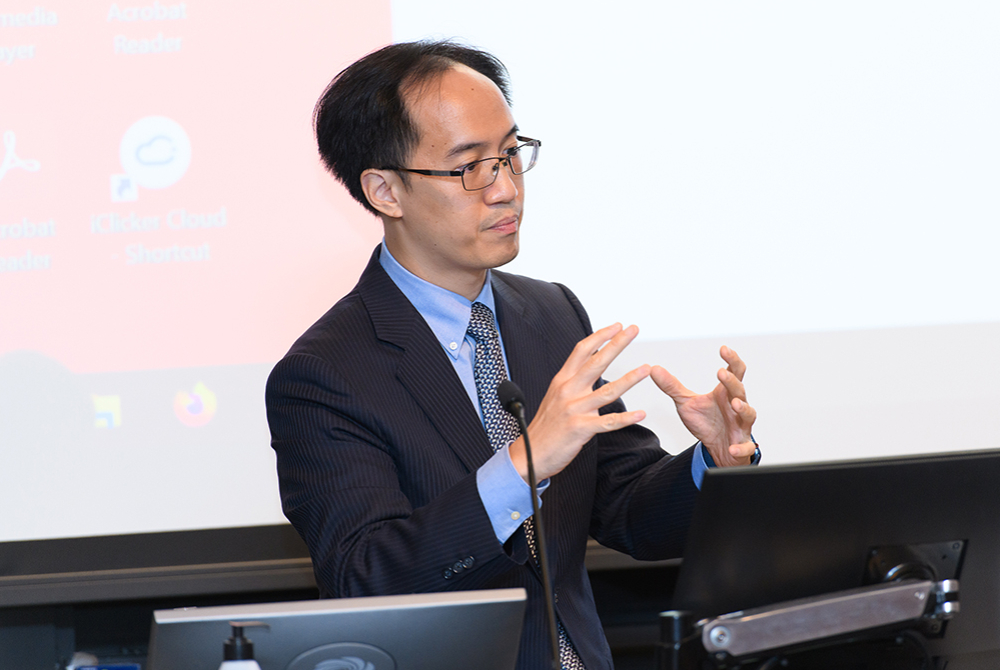 Professor Chang speaking at a podium.