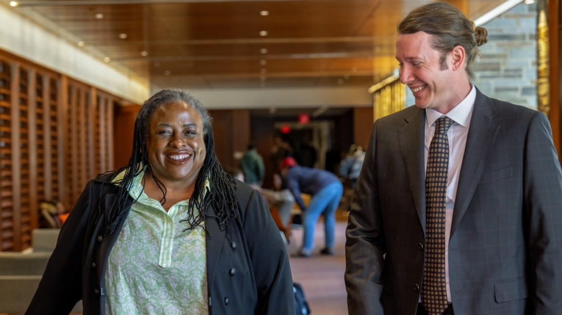 Danielle Bernard (left) and Jimmy Hardwick (right) smiling in The Gallery at Cornell Law School