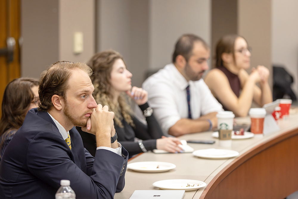 Symposium attendees sitting and listening to panel discussion.