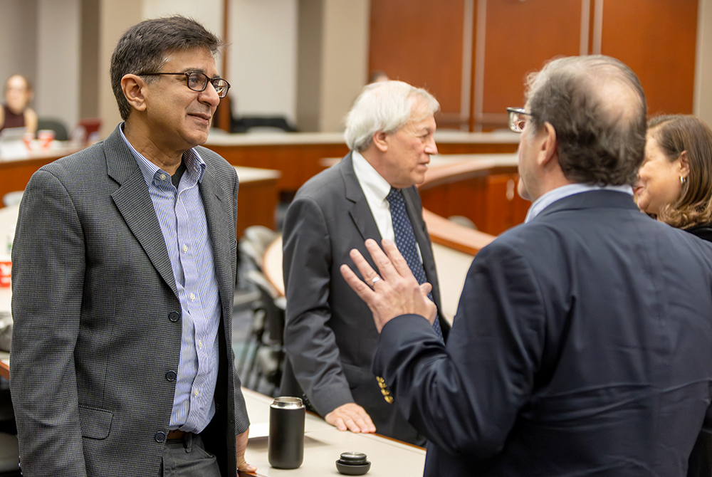 Two symposium attendees talking during a break in the programming.