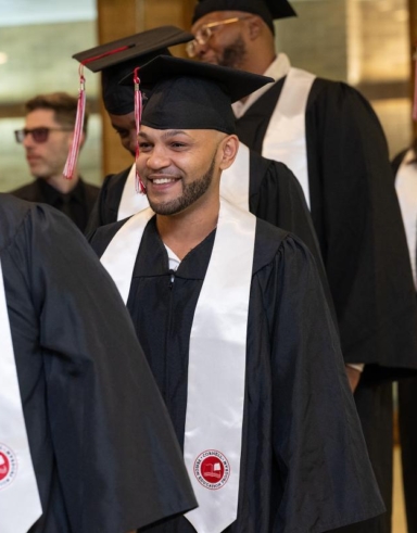 men in caps and gowns in a graduation procession