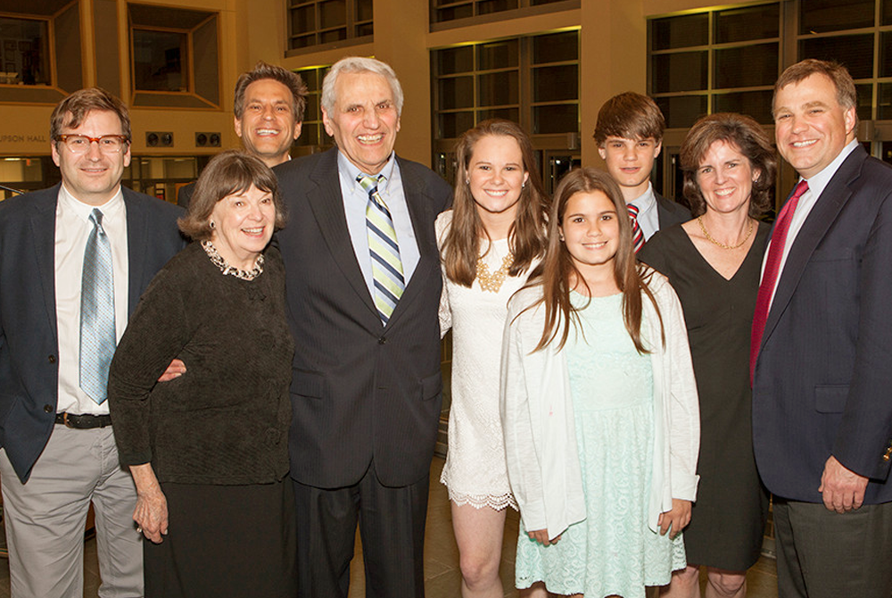 photo of Rossi in a group shot with four men and four women at an event