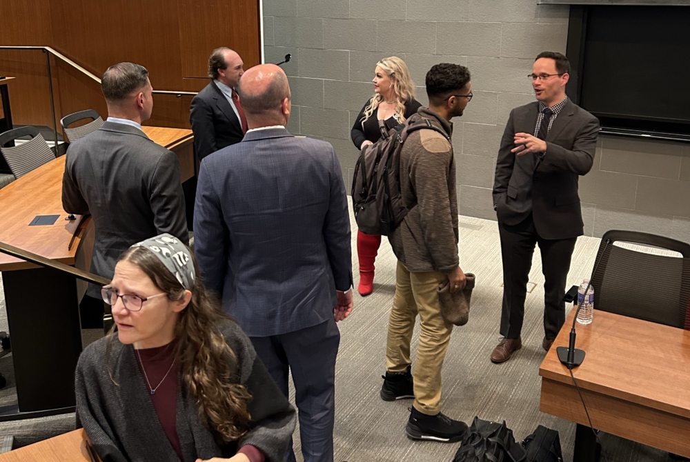 guests of a military sexual trauma survior panel event chatting with the panelists after the event