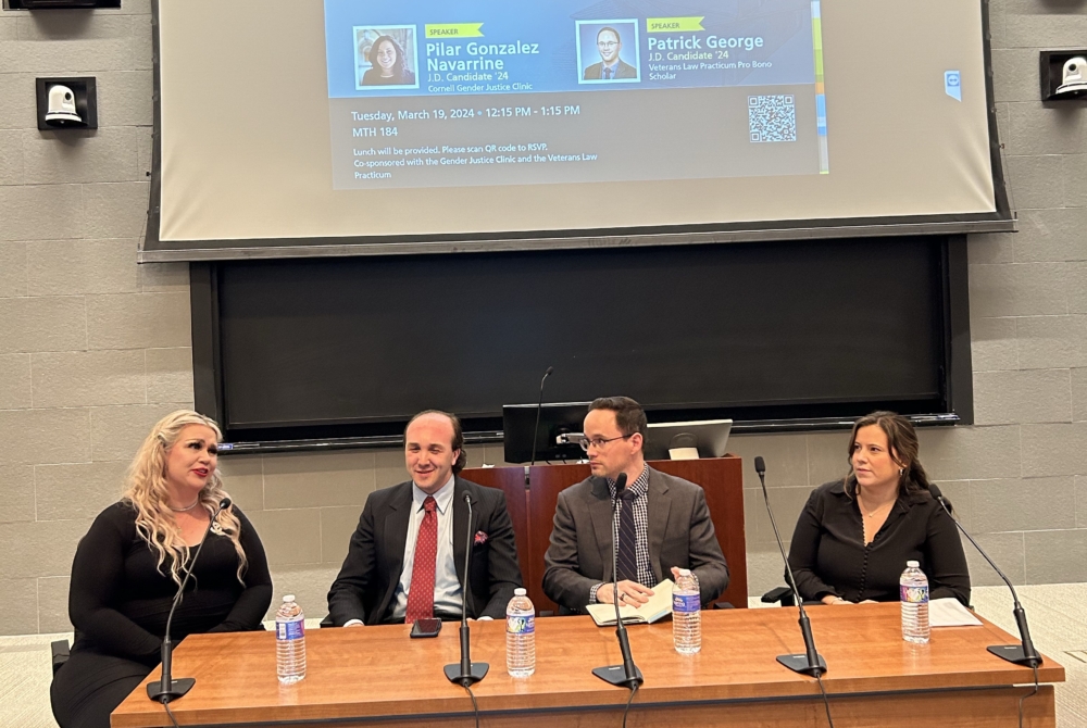 Panelists from a military sexual assault panel from March 2024- screen in background with powerpoint on it