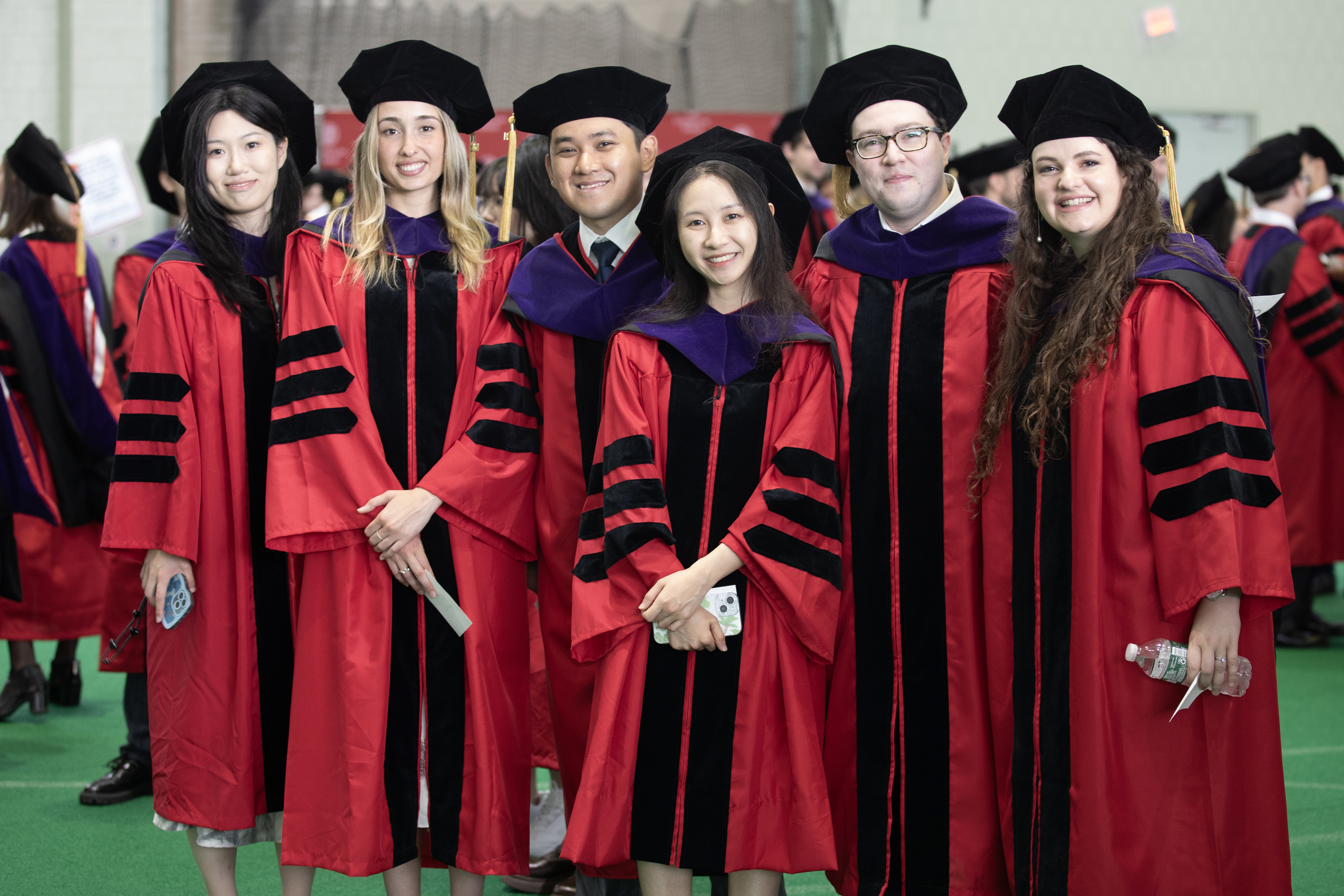 a group of students posing for a picture in their regalia
