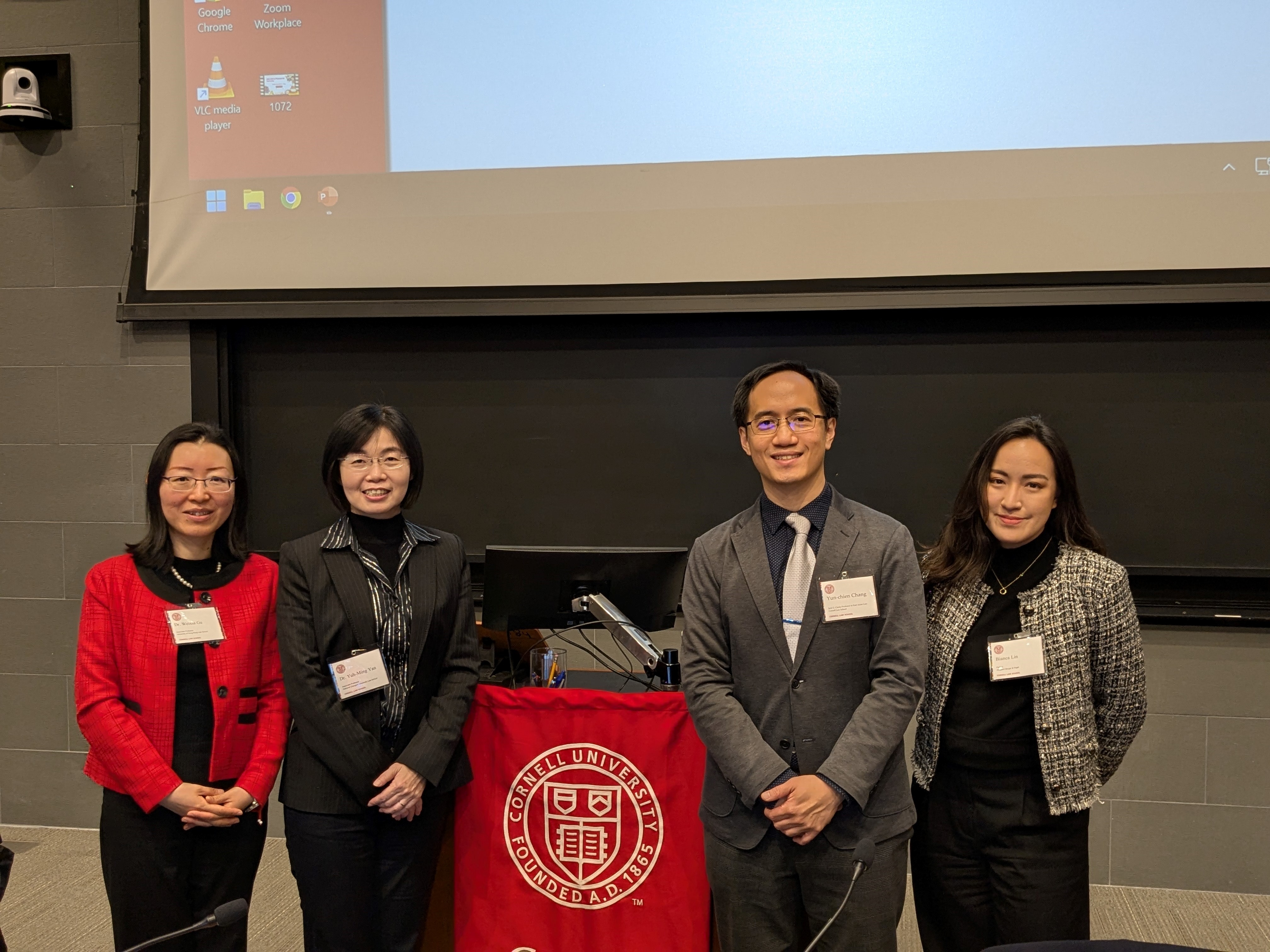 moderators and speakers posing for photo at an event
