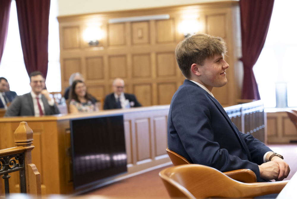 Elliot King sitting at table during Moot Court competition.