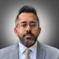 Gautam Hans on gray background.