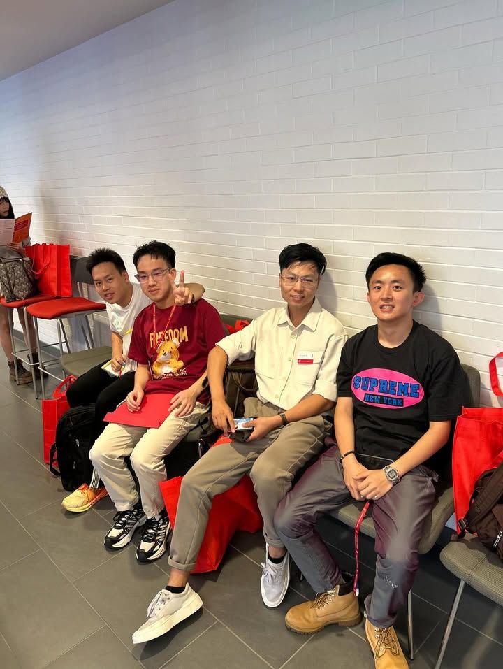 4 llm students sitting and posing for photo