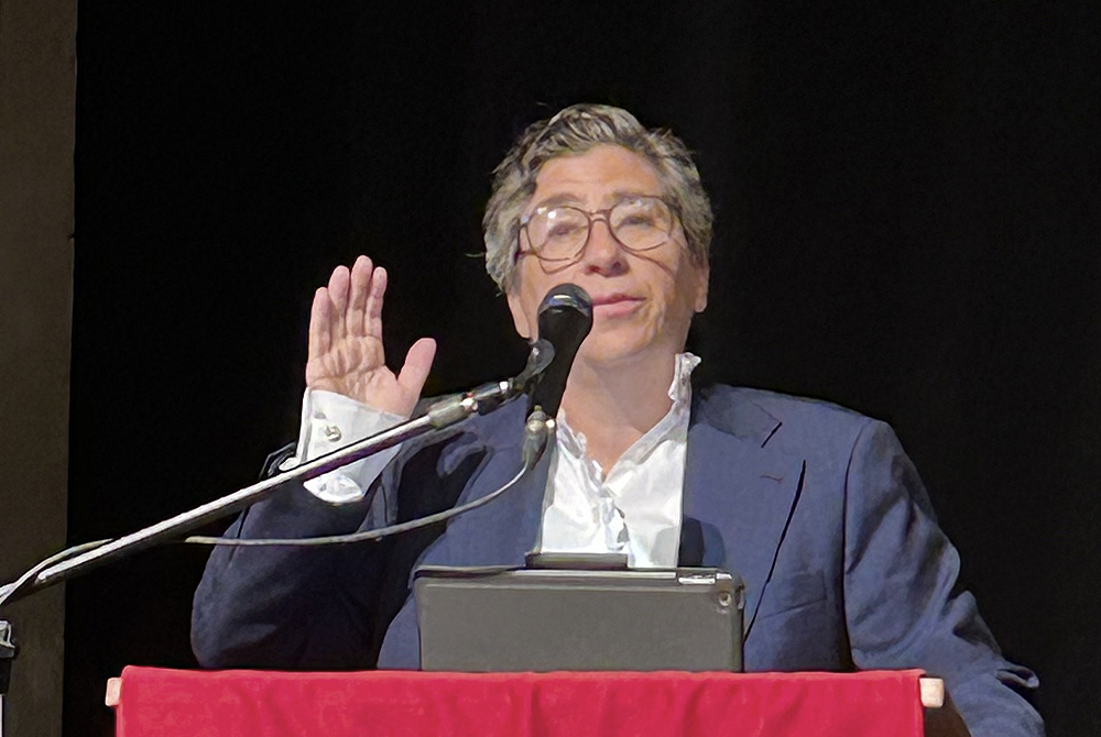 Judge Nathan reciting oath of professionalism with her hand up at podium
