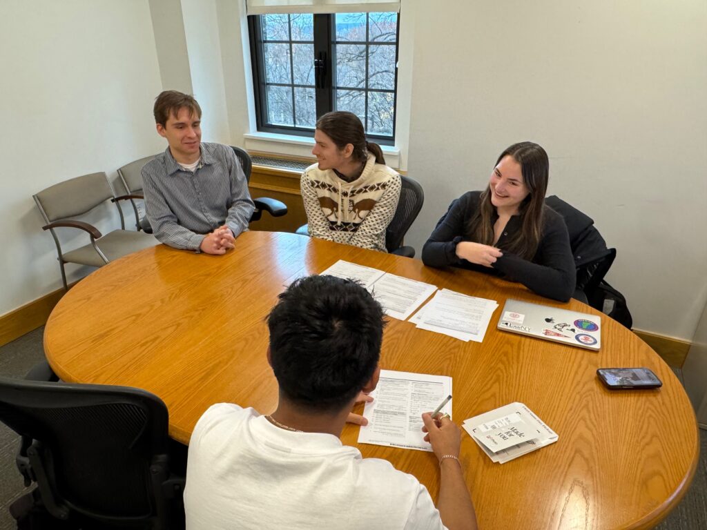 three law students with their client