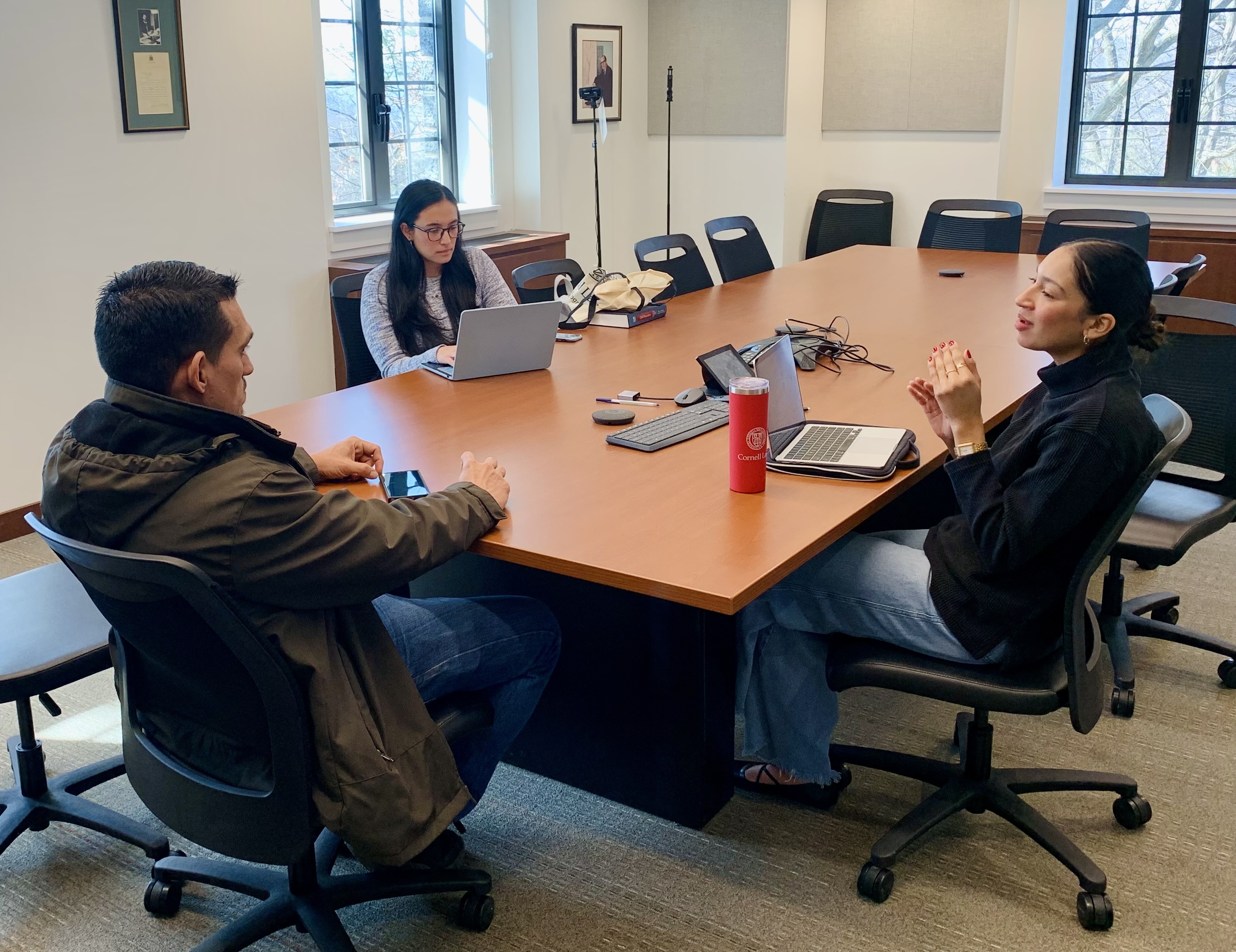 two law students meeting with their client