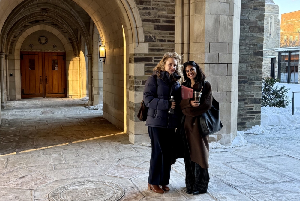 two law students in an arched corridor