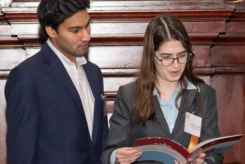 two students reading a pamphlet