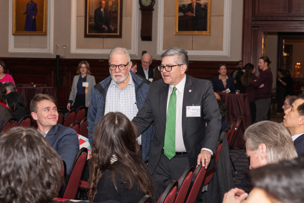 two faculty talking to students