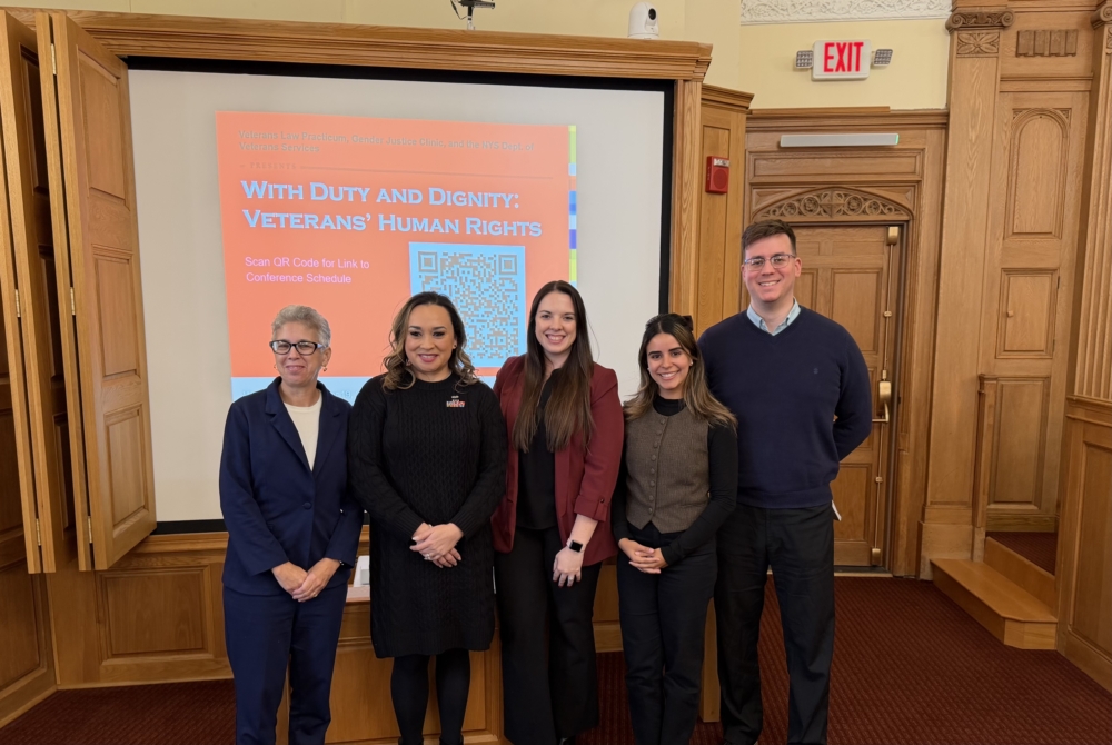 Estefania Solis '27 and other students posing in front of projector screen