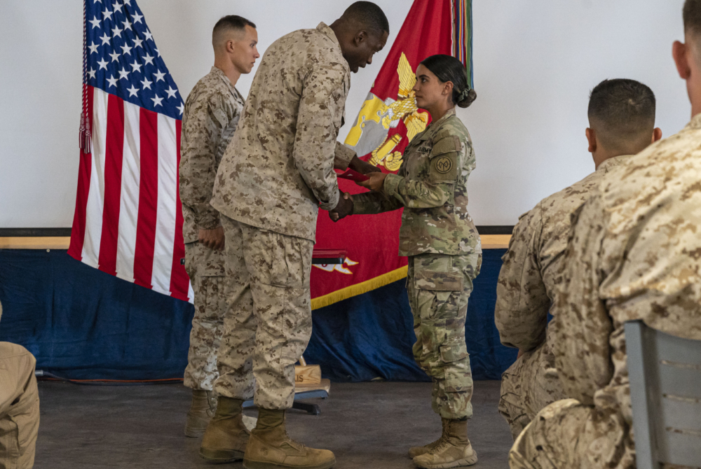 Estefania Solis '27 receiving accolades from her National Guard commander