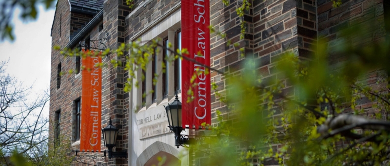 Campus building with red and orange banners that read 