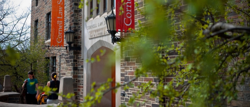 Campus building with red and orange banners that read 