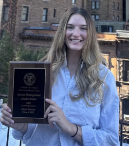 young woman holding a plaque