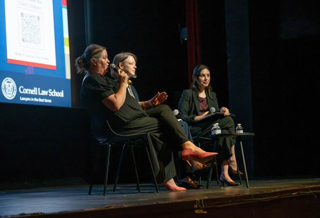Speakers talking on stage during event.